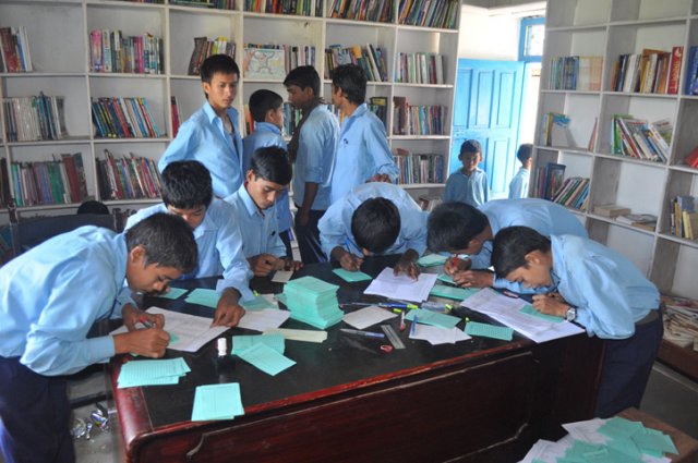 Students of Dharapani helping out with the coding during their lunch break image